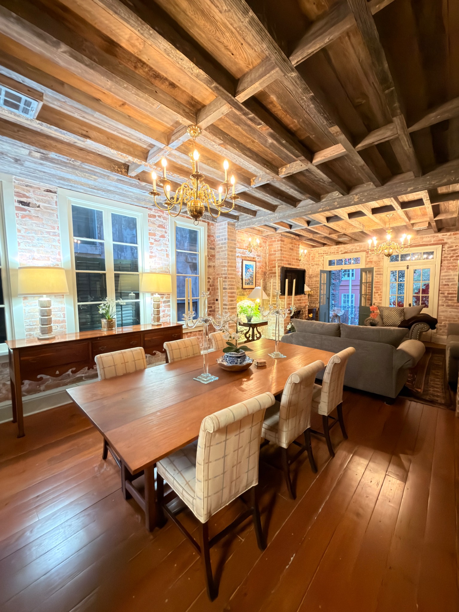 Dining room with exposed brick walls and antique chandeliers