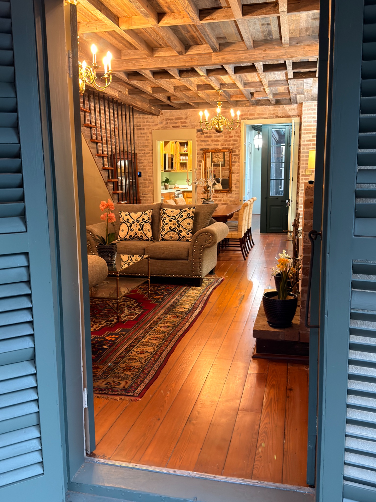 View into the residence through blue shuttered doors