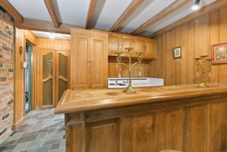 Level one efficiency suite kitchenette with historic wood cabinetry